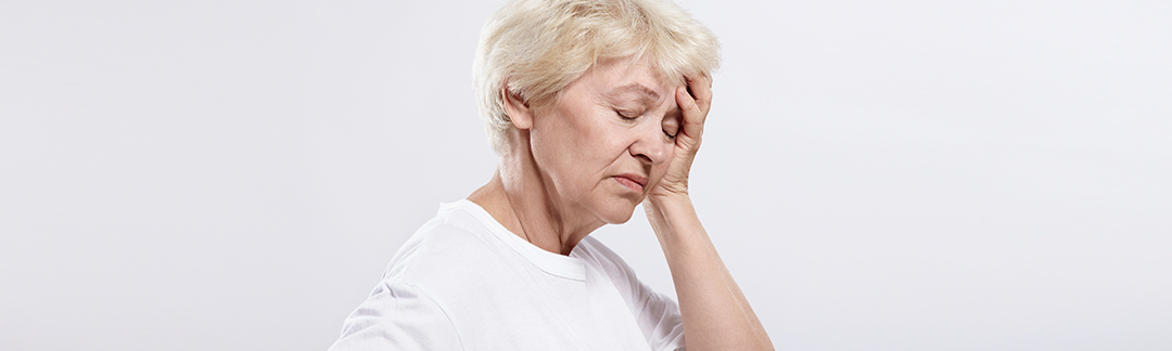 A elderly woman experienceing a headache due to variceal bleeding.