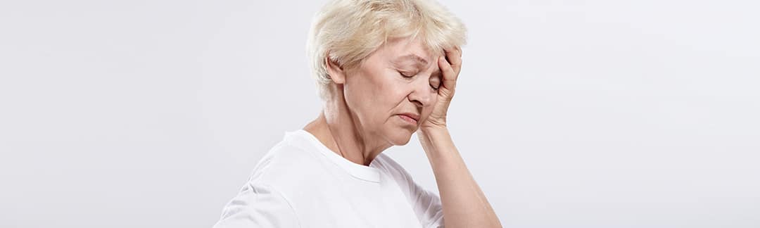 A elderly woman experienceing a headache due to variceal bleeding.