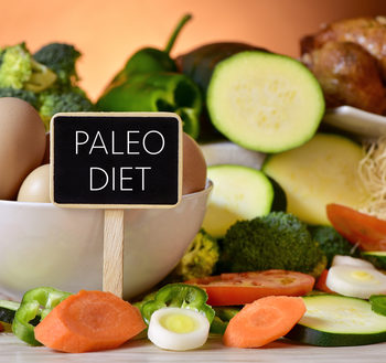 closeup of a signboard with the text paleo diet on a table