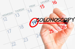 Patient writes down an appointment for a colonoscopy on a personal calendar.